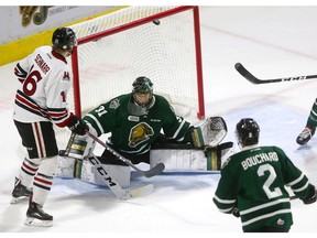 London Knights goalie Jordan Kooy loses a deflection, which bounces off the crossbar behind him with Guelph's Nate Schnarr on the doorstep during first period action at Budweiser Gardens on Friday in Game 5 of the second round of the playoffs. (Mike Hensen/The London Free Press)
