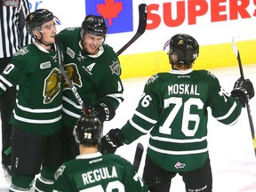 Alex Formenton celebrates with his teammates after he ties the game at 1-1 with less than a minute to play in the first period of their game against the Guelph Storm.  (Mike Hensen/The London Free Press)