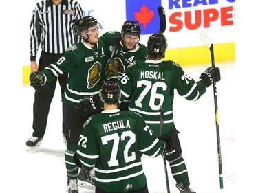Alex Formenton celebrates with his teammates after he ties the game at 1-1 with less than a minute to play in the first period of the London Knights game against the Guelph Storm. With Formenton are William Lochead, Billy Moskal and Alec Regula at Budweiser Gardens on Friday. (Mike Hensen/The London Free Press)