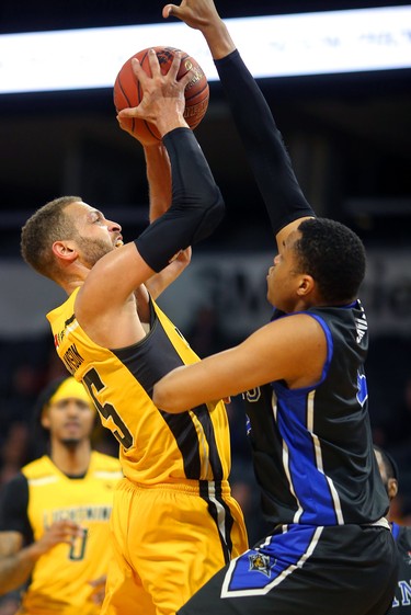 Garrett Williamson is fouled by Justin Strings of the Kitchener Waterloo Titans as the Titans dominated the Bolts Sunday at Budweiser Gardens. London lost 103-91, and now must watch from the sidelines with their playoff dreams quashed. Mike Hensen/The London Free Press/Postmedia Network