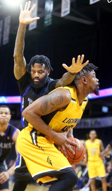 Marvin Phillips of the London Lightning looks for room under the hoop as he's guarded by Akeem Ellis of the Titans in the fifth and final game of their playoff series, which Kitchener took with a 103-91 win Sunday. Mike Hensen/The London Free Press/Postmedia Network