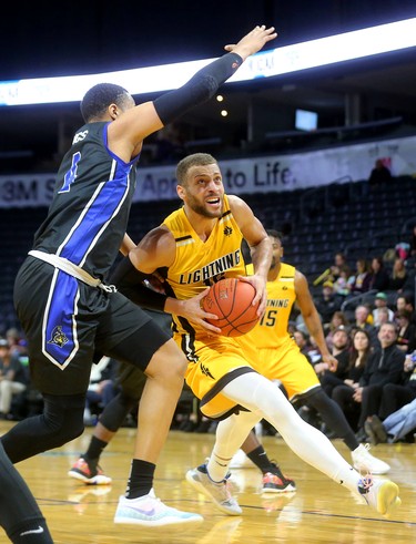 Garrett Williamson of the London Lightning can't get a good look around Justin Strings of the Titans in the fifth and final game of their playoff series. Kitchener dominated the Forest City squad, winning handily 103-91. Mike Hensen/The London Free Press/Postmedia Network