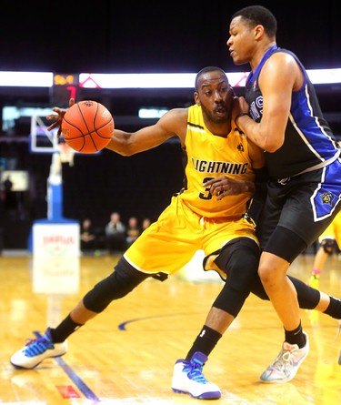 Kirk Williams Jr. of the London Lightning leans into Justin Strings  of the Kitchener Waterloo Titans on Sunday at Budweiser Gardens. Kitchener dominated, winning winning 103-91 and bringing the Lightning's season to a close. Mike Hensen/The London Free Press/Postmedia Network