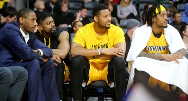 An injured Marcus Capers watches with the Lightning big men, Marvin Phillips, Rudolphe Joly and Mo Bolden while the Lightning try to score threes late in the 5th and final game of their playoff series against the Kitchener Waterloo Titans Sunday at Budweiser Gardens. The Bolts lost 103-91. Mike Hensen/The London Free Press/Postmedia Network