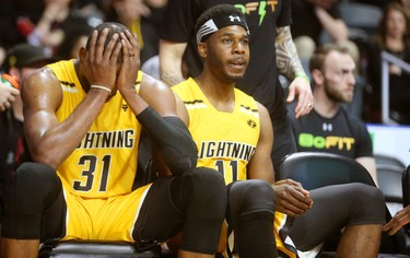 Kirk Williams Jr, wipes his face as teammate Jaylen Babb-Harrison looks on late in the 5th and final game of the London Lightning's series against the Kitchener Waterloo Titans Sunday at Budweiser Gardens. The Bolts lost 103-91, ending the team's season, Mike Hensen/The London Free Press/Postmedia Network