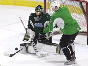 Connor McMichael tips the puck in front of goalie Jordan Kooy during London Knights practice at Budweiser Gardens in London, Ont. on Monday April 15, 2019. (Derek Ruttan/The London Free Press)