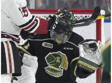 London Knight goalie Jordan Kooy makes a perfect catch even while screened by Liam Hawel of the Guelph Storm during the first period of game seven in their playoff series on Tuesday April 16, 2019. Derek Ruttan/The London Free Press