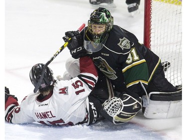 Liam Hawel of the Guelph Storm crashes into London Knights goalie Jordan Kooy during the second period of game seven in their playoff series on Tuesday April 16, 2019. Derek Ruttan/The London Free Press