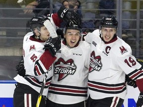 Nick Suzuki celebrates his goal with Guelph Storm teammates  Dimitri Samorukov, left, and Isaac Ratcliffe during the second period of game seven in their playoff series on Tuesday April 16, 2019. (Derek Ruttan/The London Free Press)