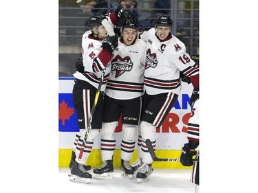 Nick Suzuki celebrates his goal with  Guelph Storm  teammates  Dimitri Samorukov, left, and Isaac Ratcliffe during the second period of game seven in their playoff series on Tuesday April 16, 2019. Derek Ruttan/The London Free Press