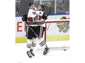 Guelph Storm players MacKenzie Entwistle, left, and Nick Suzuki jump for joy after Entwistle's empty net goal cemented a 6-3 Game 7 victory over the London Knights in London on Tuesday April 16, 2019. (Derek Ruttan/The London Free Press)