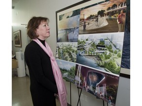 London Community Foundation Martha Powell looks at some concept art of the Back to the River project on Wednesday April 17, 2019. (Derek Ruttan/The London Free Press)