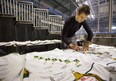 Knights captain Evan Bouchard signs souvenir team sweaters at Budweiser Gardens on Wednesday April 17, 2019.  (Mike Hensen/The London Free Press)