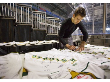 Knights captain Evan Bouchard signs souvenir team sweaters at Budweiser Gardens on Wednesday April 17, 2019.  (Mike Hensen/The London Free Press)