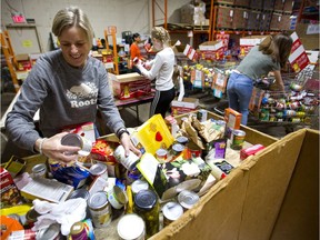Teacher Cathy Clarke uses her day off to help sort donations as the London Food Bank wraps up its spring food drive on Easter Monday. The drive drew more than 21.600 kilos of food this year, with some donations collected at large grocery stores still to be counted. (Mike Hensen/The London Free Press)
