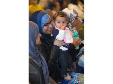 Hafsa Saleemi holds her niece Nura Gahnoog at an interfaith service for the Sri Lankan Easter attacks at St. Aidan's Anglican Church on Thursday. The service drew politicians, leaders from Jewish, Muslim, Anglican, Roman Catholic faiths as well as the London Sri Lankan community. (Mike Hensen/The London Free Press)