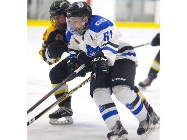 London National Max Vinogradov tries to get around Blake Petterle of the Waterloo Siskins, but the Nats were a step behind all night as Waterloo opened a 5-1 lead by the end of the second in the first game of their Sutherland Cup final on Thursday at Western Fair.  (Mike Hensen/The London Free Press)