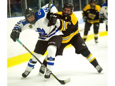 Adam Keyes of the London Nationals gets a rough ride from Alex Cimino of the Waterloo Siskins as Waterloo opened a 5-1 lead by the end of the second in the first game of their Sutherland Cup final on Thursday at Western Fair.  (Mike Hensen/The London Free Press)