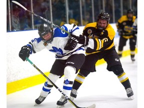 Adam Keyes of the London Nationals gets a rough ride from Alex Cimino of the Waterloo Siskins as Waterloo opened a 5-1 lead by the end of the second in the first game of their Sutherland Cup final on Thursday at Western Fair.  (Mike Hensen/The London Free Press)