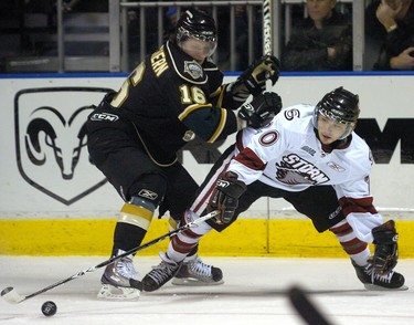 London Knight winger Dylan MacEachern checks  Guelph Storm forward Daniel Erlick during an Ontario Hockey League game played at the John Labatt Centre in London on Sunday February 13, 2011. WITH STORY BY RYAN PYETTE MORRIS LAMONT / THE LONDON FREE PRESS / QMI AGENCY