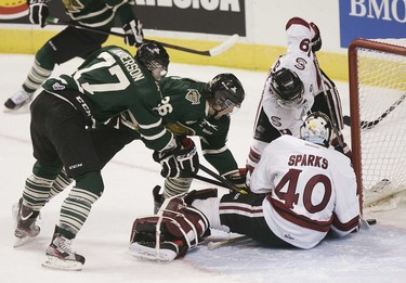 London Knights Colin Martin Josh Anderson stab at a loose puck pushing it over the line for the first goal of the hockey game despite the efforts of Garrett Sparks and Hunter Garlent of the Guelph Storm at the John Labatt Centre in London, Ontario on Friday, December 16, 2011. The goal was credited to Chris Tierney.DEREK RUTTAN/THE LONDON FREE PRESS/QMI AGENCY