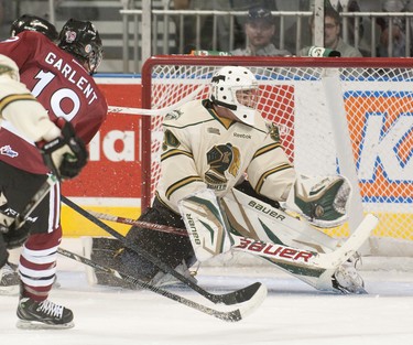 London Knights goaltender Kevin Bailie stops the puck with his glove after a shot on net from Guelph Storm forward Hunter Garlent during their OHL hockey game at Budweiser Gardens in London on Sunday September 30, 2012. CRAIG GLOVER The London Free Press / QMI AGENCY