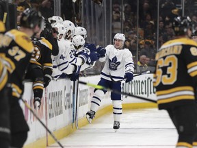 Toronto Maple Leafs right wing Mitchell Marner, right rear, is congratulated by teammates after his penalty-shot goal off Boston Bruins goaltender Tuukka Rask during the second period of Game 1 of an NHL hockey first-round playoff series Thursday, April 11, 2019, in Boston. (AP Photo/Charles Krupa) ORG XMIT: MACK106