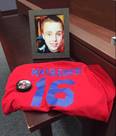The family of Michael Maukonen, 19, of Windsor placed his photograph along with his hockey jersey and a puck for the five-person jury to see during a coroner’s inquest into the deaths of three roofers across the region that began in Chatham on Monday. (Ellwood Shreve/Postmedia)