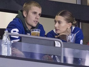 Justin Bieber watches alongside his wife Hailey Baldwin, right, during NHL hockey action between the Philadelphia Flyers and the Toronto Maple Leafs, in Toronto on Saturday, Nov. 24, 2018.
