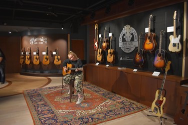Belmont University student Emma Crockett strums a guitar at the Gallery of Iconic Guitars (GIG). There are 500 unique and irreplaceable guitars and stringed instruments in the collection, donated by Steven Kern Shaw, grandson of musical theatre composer Jerome Kern, whose work included Show Boat, and son of bandleader Artie Shaw.  (WAYNE NEWTON photo)
