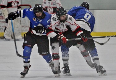 London Nationals James Turner, left, and Christian Polillo sandwich Listowel Cyclone Trent Verbeek during the first period of the Sutherland Cup semifinal Game 4 Tuesday night at the Steve Kerr Memorial Complex. (Cory Smith/Postmedia Network)