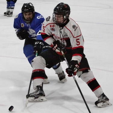 Listowel Cyclones forward Trent Verbeek tries to go wide on London Nationals defenceman Nicolas Hatzikiriakos during the first period of the Sutherland Cup semifinal Game 4 Tuesday night at the Steve Kerr Memorial Complex. (Cory Smith/Postmedia Network)