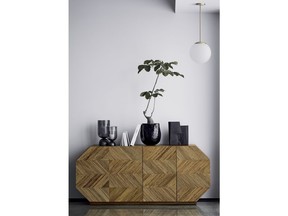 This photo provided by CB2 shows this Rattan credenza from CB2. Rattan, the darling of 60s and 70s casual design, is experiencing a major comeback as home furnishings retailers are offering updated pieces like this chic credenza. The material has a warm, textural vibe yet it can also look chic and sophisticated; all hallmarks of what's considered 'modern' design now. (CB2 via AP)