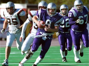 Mustang quarterback Chris Hessel runs from a crowd of players during Western's university football game against Ottawa Gee-Gees on October 2, 2004 at TD Stadium in London. (Free Press file photo)