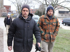 London residents Steven Ravbar, 50, and Matthew Anthony Carapella, 32, who have been charged under a city hall nuisance bylaw, walk into a London court Monday to answer to the charges. JONATHAN JUHA/THE LONDON FREE PRESS