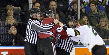 Blood flows freely from the forehead of London Knights forward Tait Seguin during a fight with Guelph Storm defenceman Ben Harpur during the first period of their game at Budweiser Gardens in London, Ont. on Friday December 13, 2013.  London led 1-0 on the strength of a last minute goal by London Knights forward Mitchell Marner. Mike Hensen/The London Free Press/QMI Agency