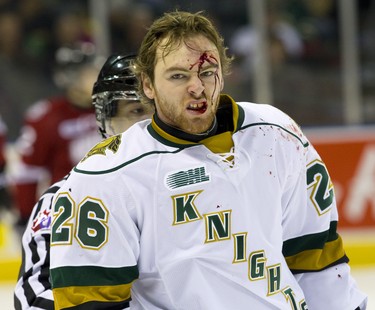 Blood flows freely from the forehead of London Knights forward Tait Seguin as he skates to the dressing room after a fight with Guelph Storm defenceman Ben Harpur during the first period of their game at Budweiser Gardens in London, Ont. on Friday December 13, 2013.  London led 1-0 on the strength of a last minute goal by London Knights forward Mitchell Marner. Mike Hensen/The London Free Press/QMI Agency