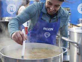 London native Rozin Abbas stirs his seafood with coconut soup, which ran short and needed to be thinned out to feed the final 20 guests at a wedding, during a team challenge on Monday's MasterChef Canada on CTV.