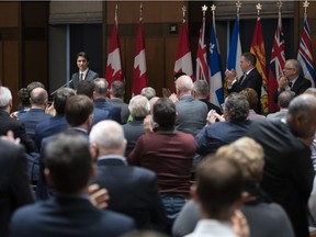 Members of the Liberal Caucus give a standing ovation to Prime Minister Justin Trudeau after his speech informing them he had removed Jody Wilson-Raybould and Jane Philpott from caucus.