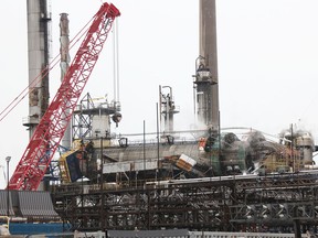 Cranes are being assembled to lift a toppled tower at Imperial Oil's Sarnia plant. Tyler Kula/Sarnia Observer/Postmedia Network