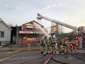 Firefighters battle a morning blaze in a variety store that's also home to apartments. Two people, including a firefighter, were taken to hospital. Photo taken Thursday April 18, 2019. (Jonathan Juha/The London Free Press)