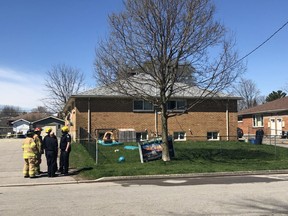 Police and fire officials are seen outside a fourplex building on Stratton Drive, where a fire broke out in one of the units, sending one man to hospital with life-threatening injuries and displacing a dozen residents. (JONATHAN JUHA, The London Free Press)
