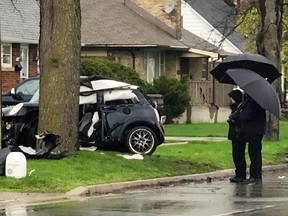 London police officers inspect the scene of a Tuesday morning crash on Clarke Road, just north of Dundas Street. (JONATHAN JUHA, The London Free Press)