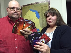 Grand Chief Joel Abram of the Association of Iroquois and Allied Indians, with responsible gambling co-ordinator Lisa Jackson, display card sets documenting the 14 grandfather teachings. The cards were funded by Gambling Research Exchange Ontario, which is being closed by the Ford government. (Heather Rivers, The London Free Press)