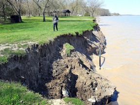 Keagan Chambers walks along the eroded shoreline at Wheatley Provincial Park in Chatham-Kent Tuesday. The provincial park is open. (Nick Brancaccio, Postmedia News)