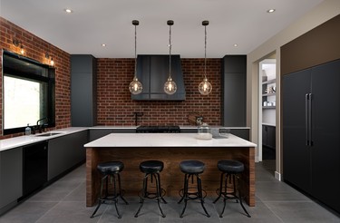 Brick walls warm up the kitchen and make the grey cabinets, wood island and quartz counters pop in contrast.
  PHOTOS: WILLIAM CHAN