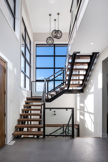 The floating staircase is enhanced by a large window. WILLIAM CHAN