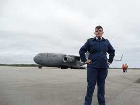 Air Cadet Sgt. Johnathan Kerepcich, 16, stands with the Canadian Armed Forced Globemaster that flew into London on Saturday. About 650 cadets from across the region came to London to see the largest transport plane in the Canadian fleet. (JANE SIMS, The London Free Press)