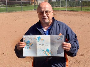 Dan Kolbylka, 64, of Chatham still has the card he received from nurses in the chronic care unit at the former Public General Hospital after he was transferred to University Hospital in London for a heart transplant on May 29, 1989. He posed for the photo on Tuesday at his favourite place, Kinsmen Field in Chatham  where he organizes Challenger Baseball for adults with disabilities. (Ellwood Shreve/Postmedia Network)