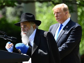 Rabbi Yisroel Goldstein, with US President Donald, speaks during the National Day of Prayer Service, in the Rose Garden of the White House in Washington, DC, on May 2,2019. - Rabbi Goldstein of Chabad of Poway was wounded on April 27 during deadly shooting at the synagogue in San Diego.